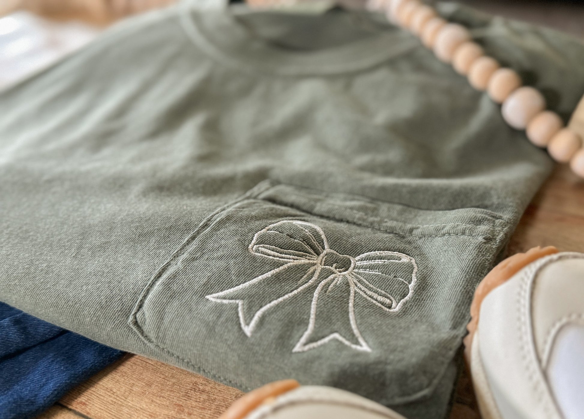Green fabric with a bow design on a wooden surface