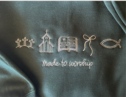 Dark Christian green sweatshirt with embroidered symbols and 'Made to Worship' text.