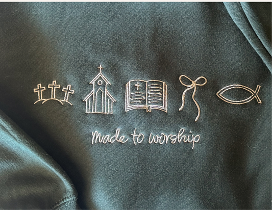 Dark Christian green sweatshirt with embroidered symbols and 'Made to Worship' text.